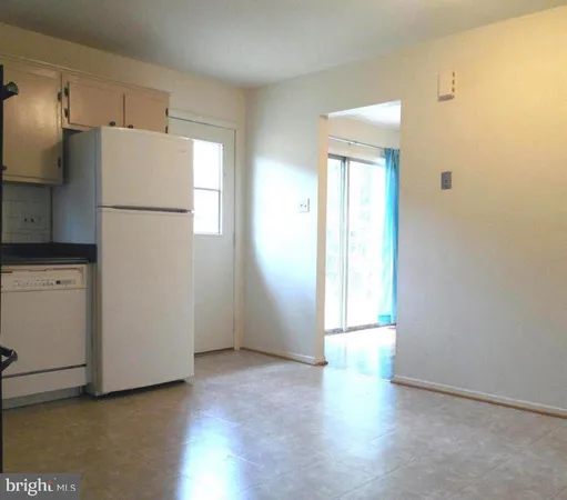 a view of a kitchen with a refrigerator cabinets and wooden floor