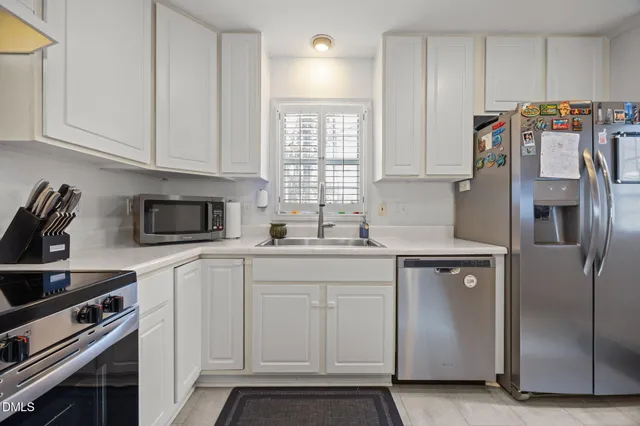 a kitchen with a white cabinets and white appliances