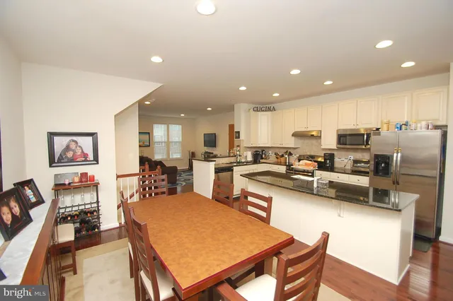 a large kitchen with a table and chairs