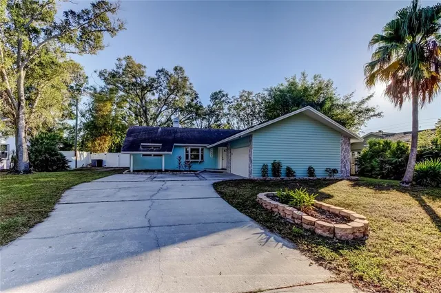a view of a hallway with wooden floor and a kitchen