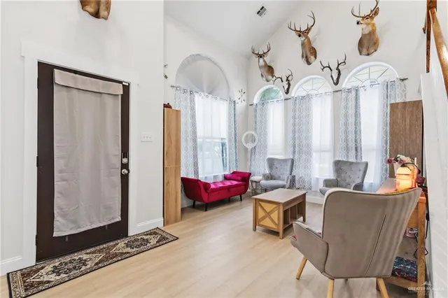 a living room with furniture and a chandelier