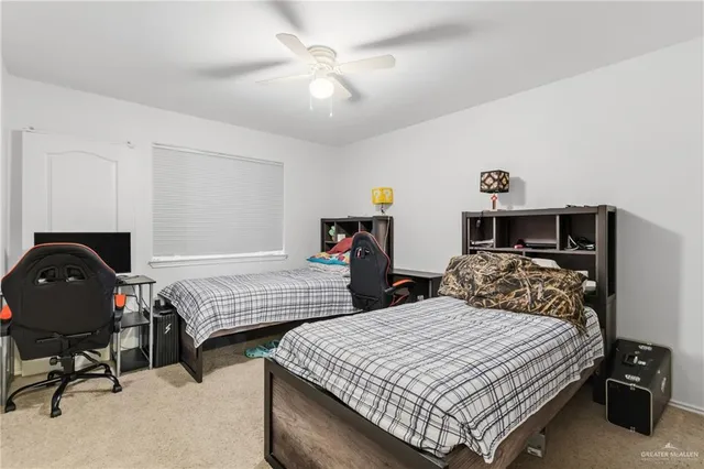 a bedroom with two bed and a chandelier