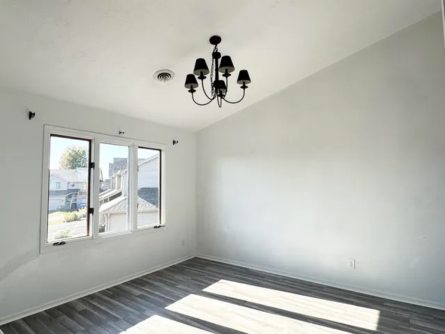 a room with window and a chandelier