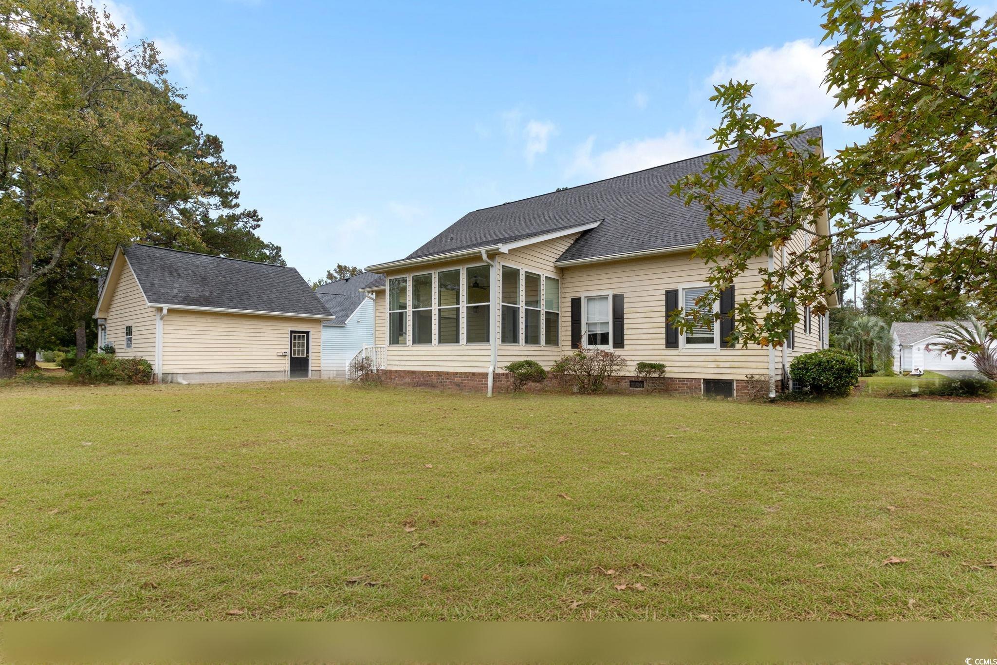 2321 Brick Drive Longs, SC 29568 - Photo 5 of 40 Rear view of property with a yard, a sunroom, a shingled roof, and crawl space