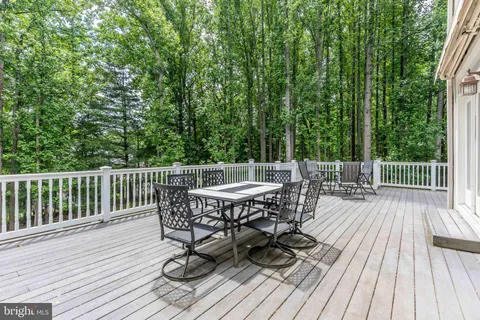 a view of a deck with furniture and wooden floor