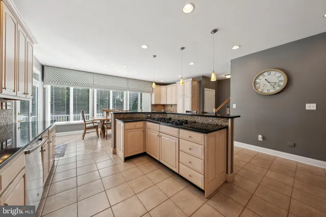 a kitchen with stainless steel appliances granite countertop a stove and a sink