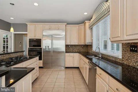 a living room with wooden floor and a entryway