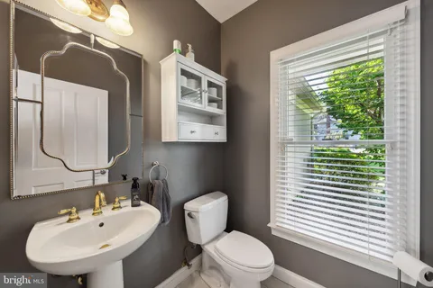a living room with furniture lamp and window