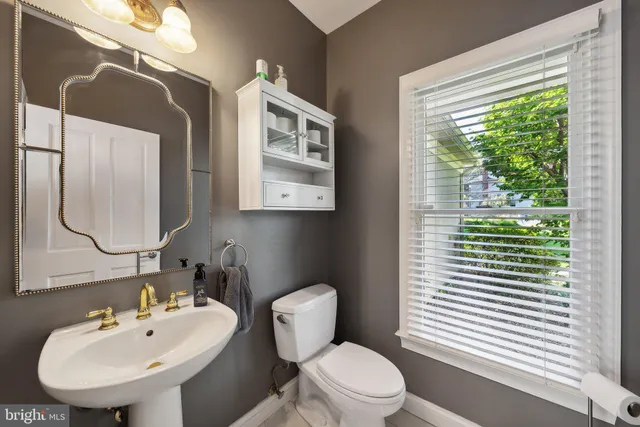 a living room with furniture lamp and window