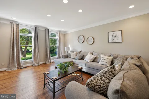 a view of a hallway with wooden floor and entryway