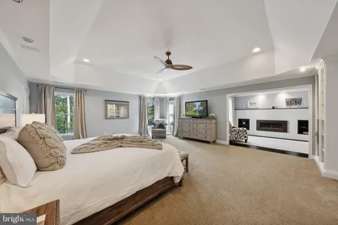 a living room with stainless steel appliances granite countertop furniture and a fireplace