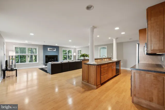 a view of kitchen with kitchen island and stainless steel appliances