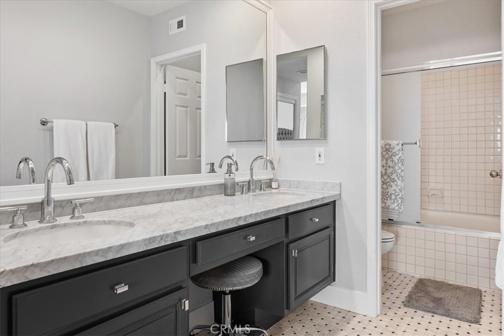 7 Centre Court Dana Point, CA 92629 - Photo 23 of 59 Remodeled guest bathroom with marble counters, bathtub and shower.