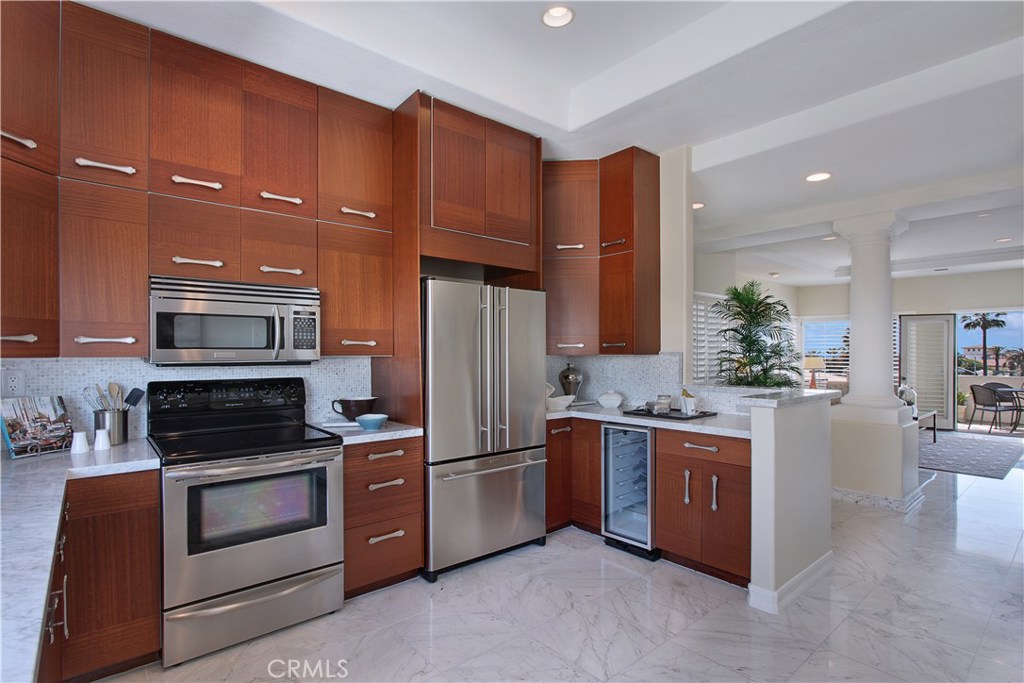 7 Centre Court Dana Point, CA 92629 - Photo 32 of 59 Remodeled kitchen with marble counters, built in range and microwave.