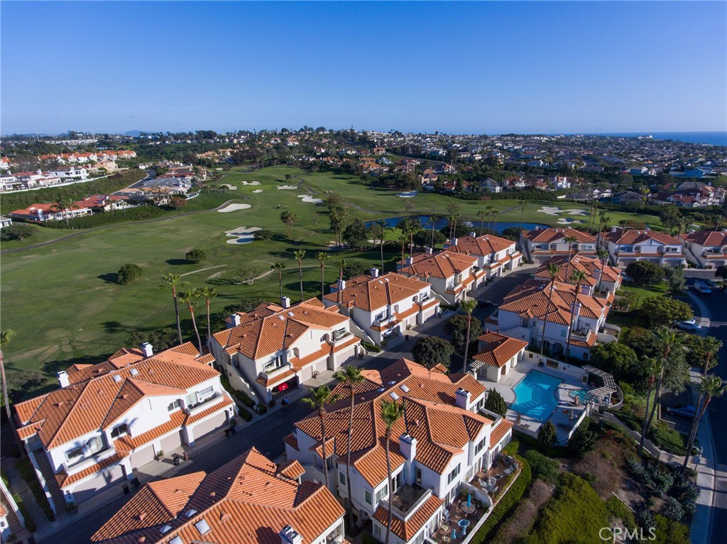 7 Centre Court Dana Point, CA 92629 - Photo 45 of 59 Aerial views over golf course, lake on golf course, community pool & spa facing south with ocean just beyond.