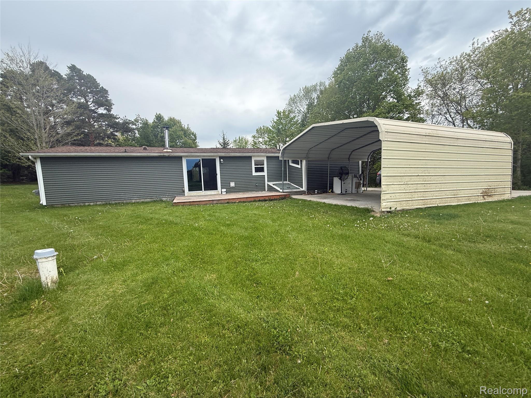 7149-7163 Burpee Road Grand Blanc, MI 48439 - Photo 14 of 72 Back of house featuring a detached carport and a yard