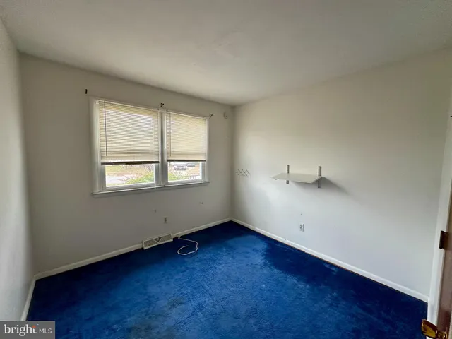 an empty room with wooden floor and closet