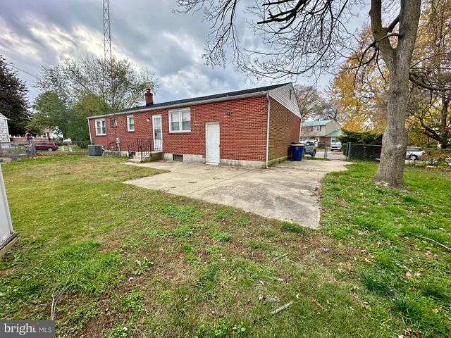 a view of a yard with a house and a large tree