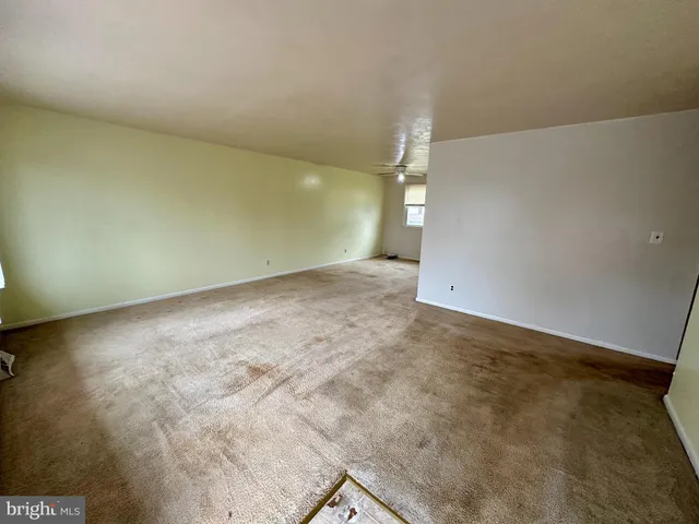 an empty room with a empty space and windows