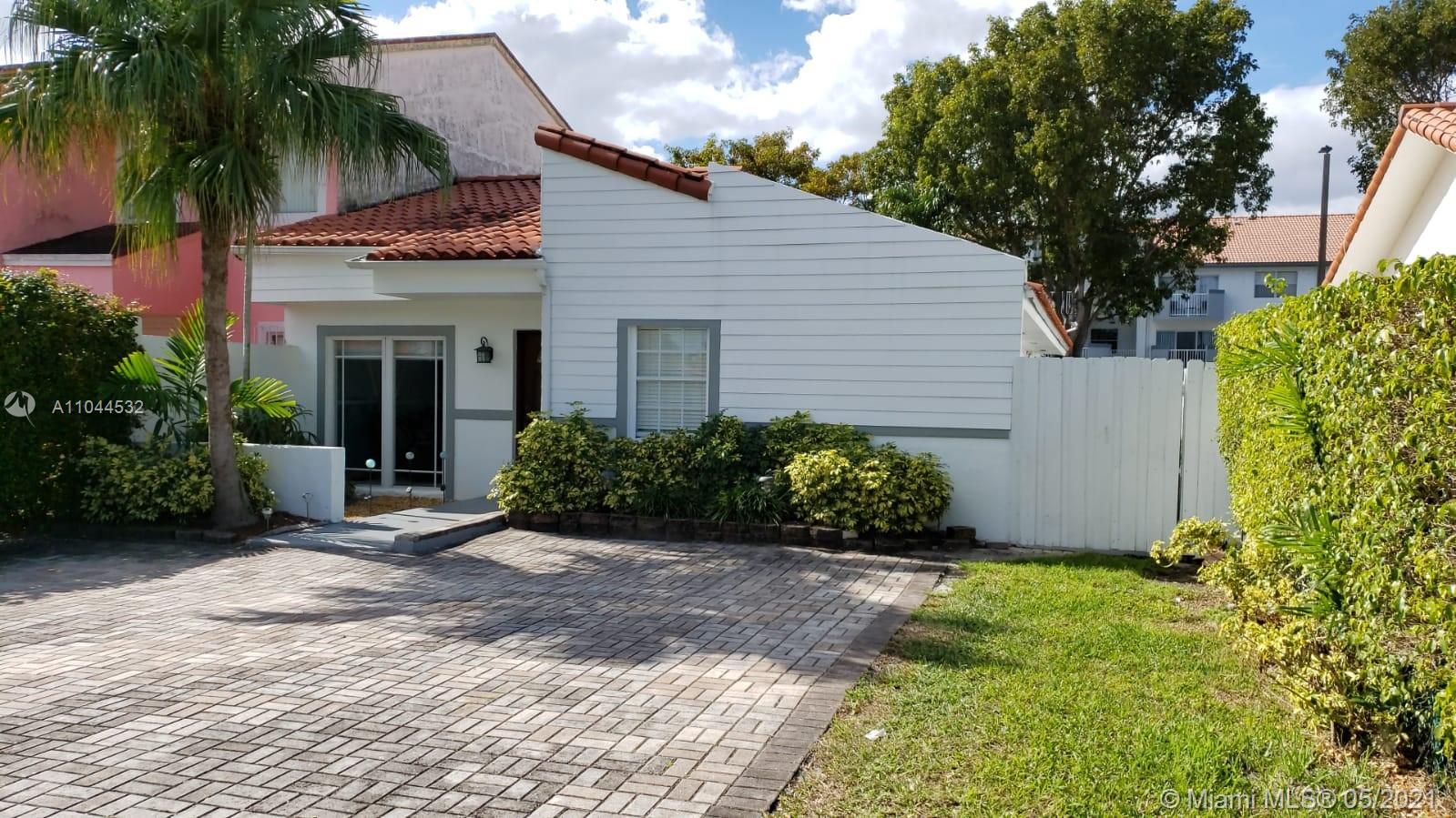1404 Southwest 104th Court, Unit 89B Miami, FL 33174 - Photo 1 of 29 a front view of house with yard and green space