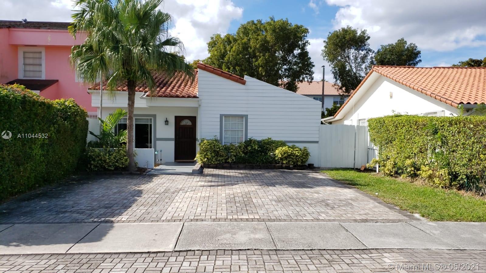 1404 Southwest 104th Court, Unit 89B Miami, FL 33174 - Photo 2 of 29 a view of a house with a yard