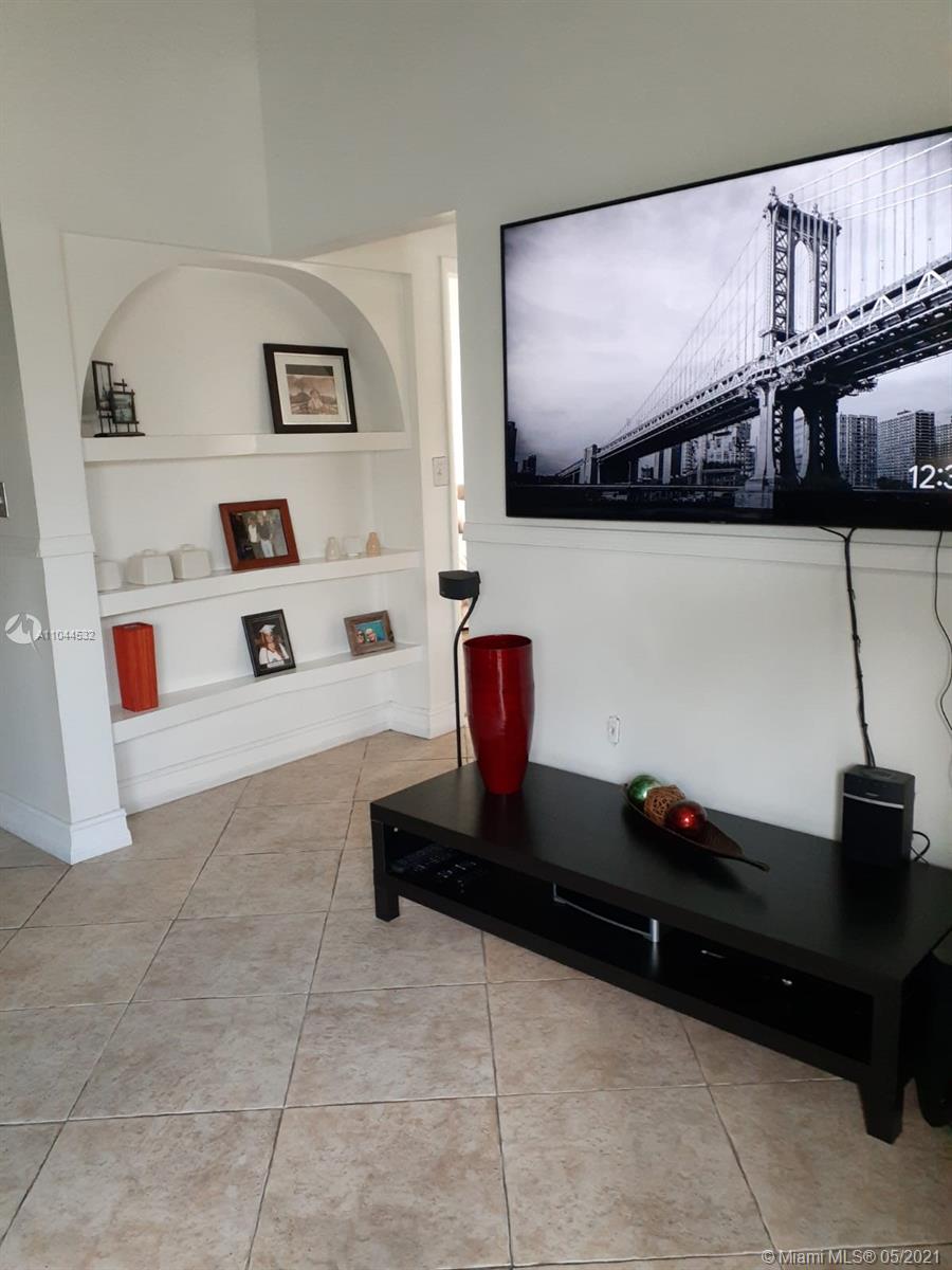 1404 Southwest 104th Court, Unit 89B Miami, FL 33174 - Photo 11 of 29 a living room with furniture and a flat screen tv