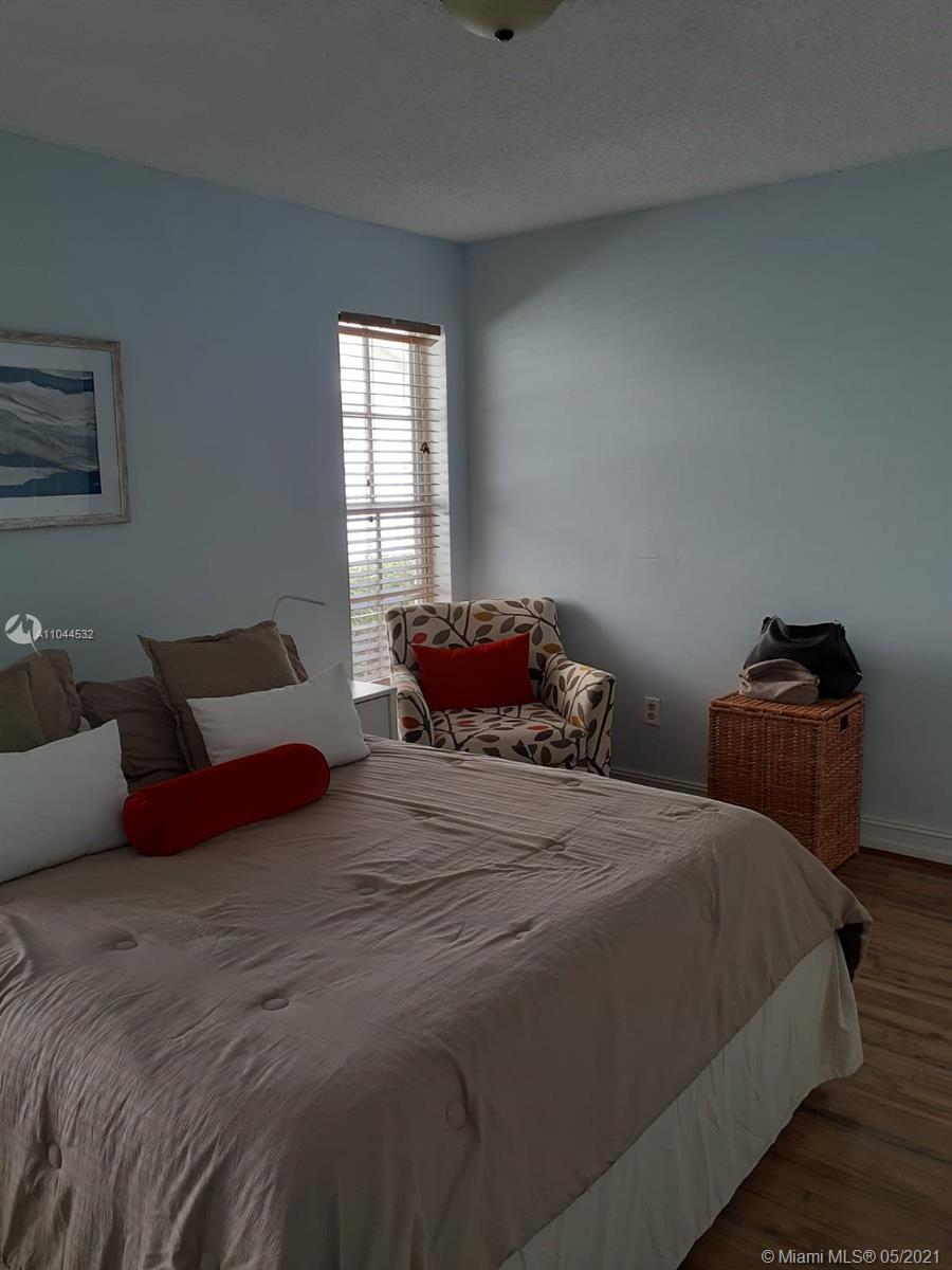 1404 Southwest 104th Court, Unit 89B Miami, FL 33174 - Photo 12 of 29 a bedroom with a bed and window