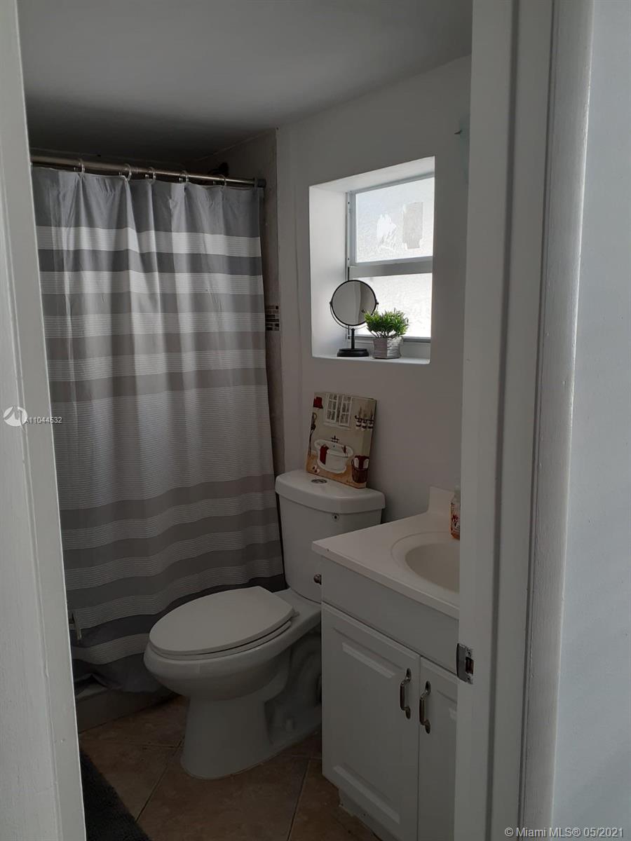 1404 Southwest 104th Court, Unit 89B Miami, FL 33174 - Photo 14 of 29 a bathroom with a sink toilet and shower
