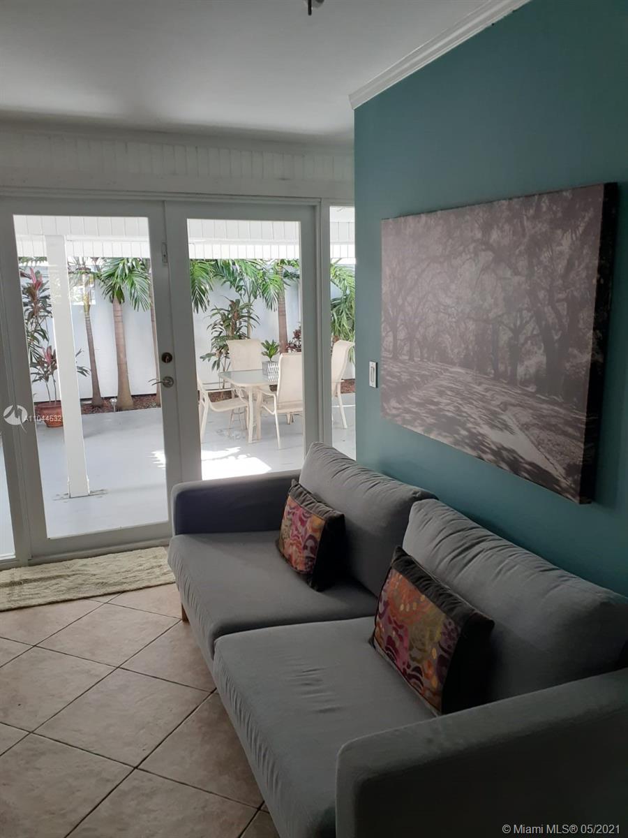 1404 Southwest 104th Court, Unit 89B Miami, FL 33174 - Photo 15 of 29 a living room with furniture and a floor to ceiling window