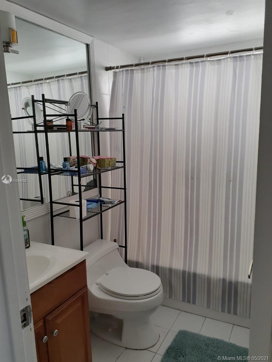 1404 Southwest 104th Court, Unit 89B Miami, FL 33174 - Photo 17 of 29 a bathroom with a toilet a sink and shower