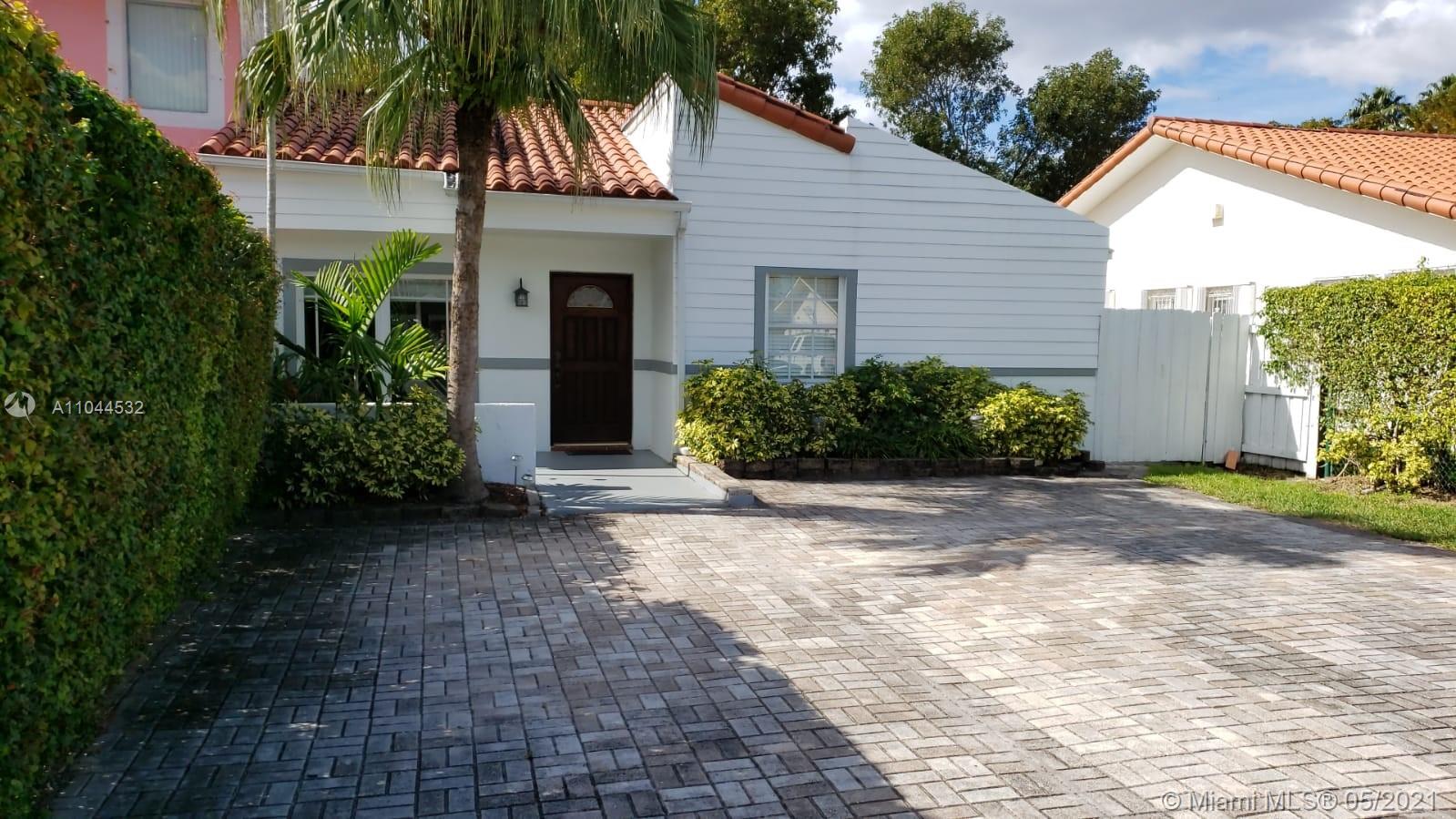 1404 Southwest 104th Court, Unit 89B Miami, FL 33174 - Photo 3 of 29 a view of a house with a yard and plants