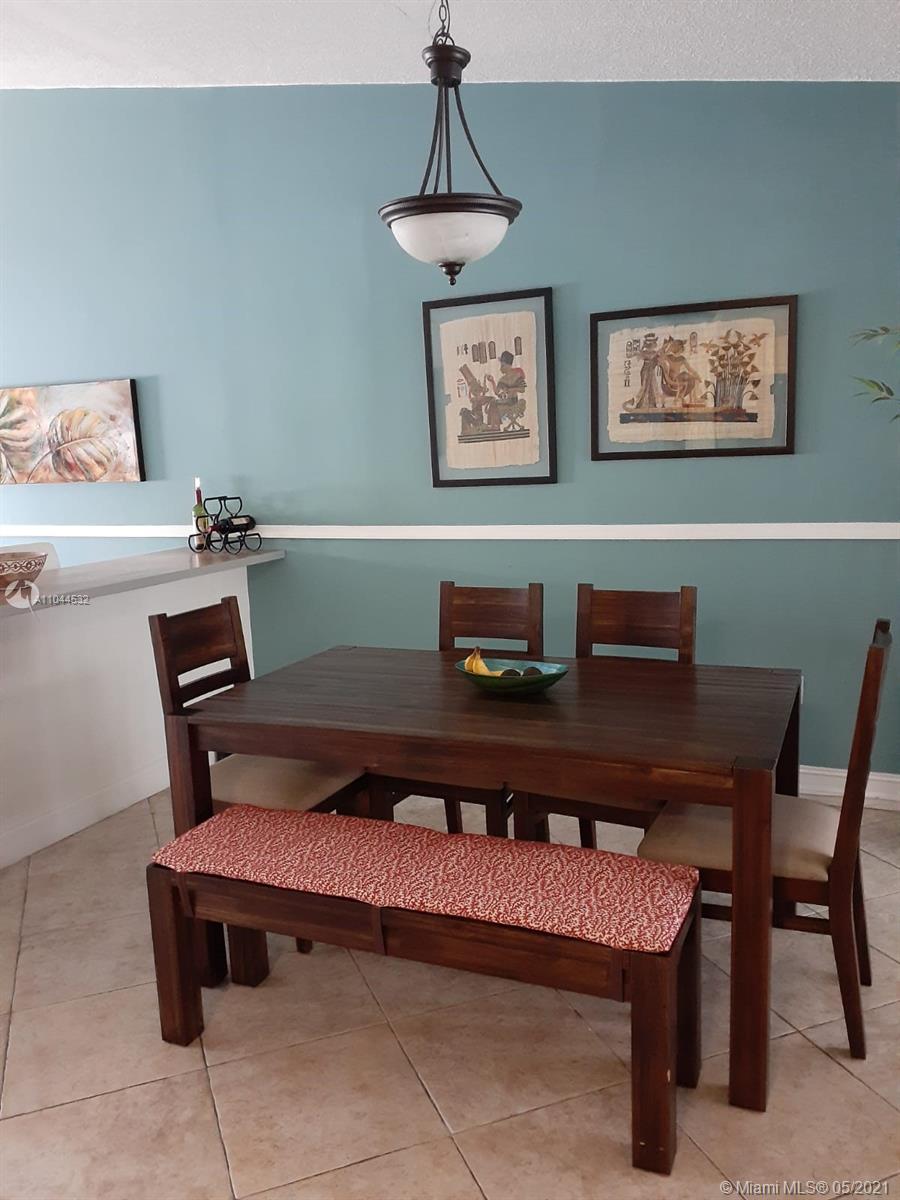 1404 Southwest 104th Court, Unit 89B Miami, FL 33174 - Photo 21 of 29 a reading room with furniture and paintings on the wall