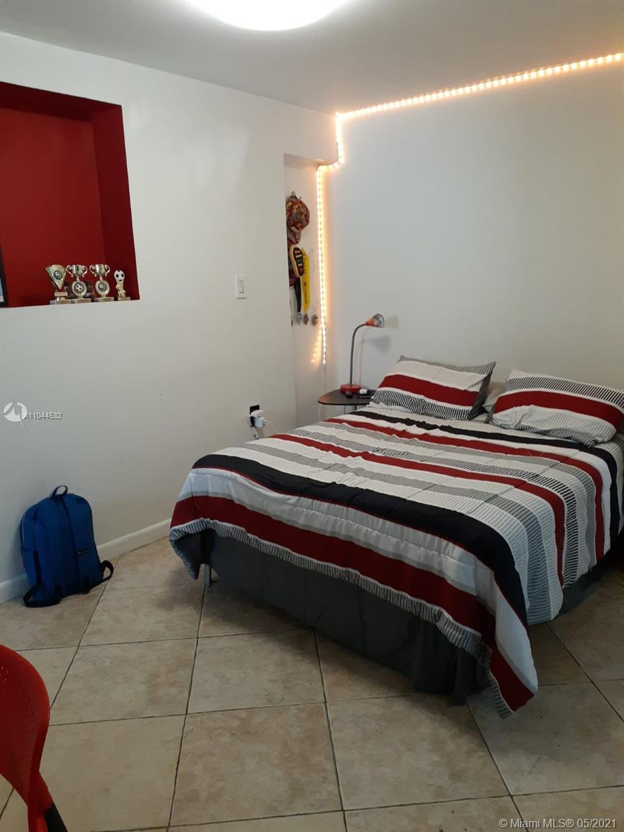 1404 Southwest 104th Court, Unit 89B Miami, FL 33174 - Photo 22 of 29 a bedroom with a bed and a window