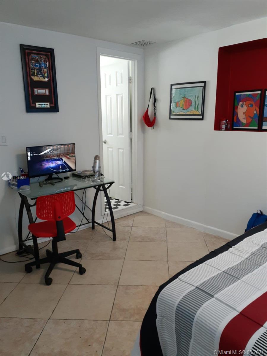 1404 Southwest 104th Court, Unit 89B Miami, FL 33174 - Photo 23 of 29 a room with a couch and a chair