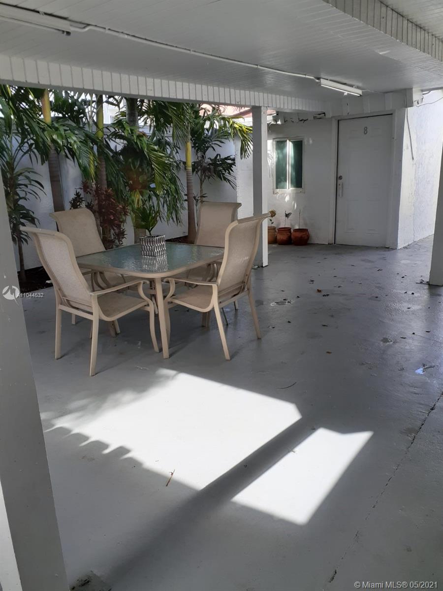 1404 Southwest 104th Court, Unit 89B Miami, FL 33174 - Photo 25 of 29 a view of a tables and chairs in patio