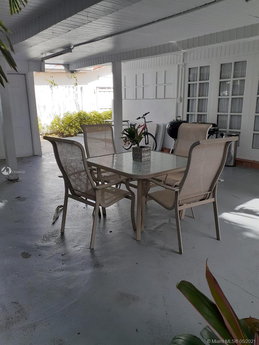 1404 Southwest 104th Court, Unit 89B Miami, FL 33174 - Photo 26 of 29 a view of a dining room with furniture and window