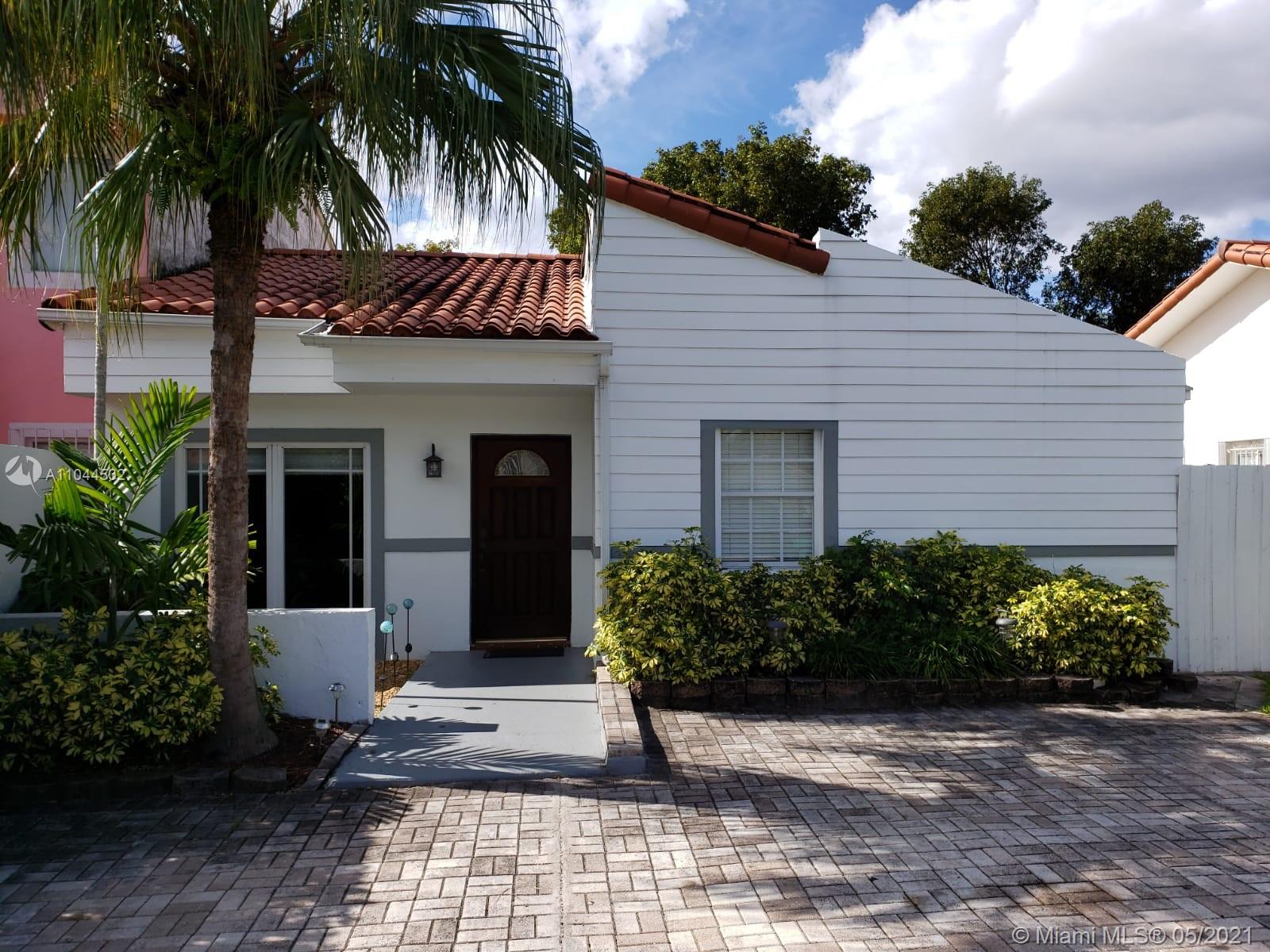 1404 Southwest 104th Court, Unit 89B Miami, FL 33174 - Photo 4 of 29 a front view of a house with a garden