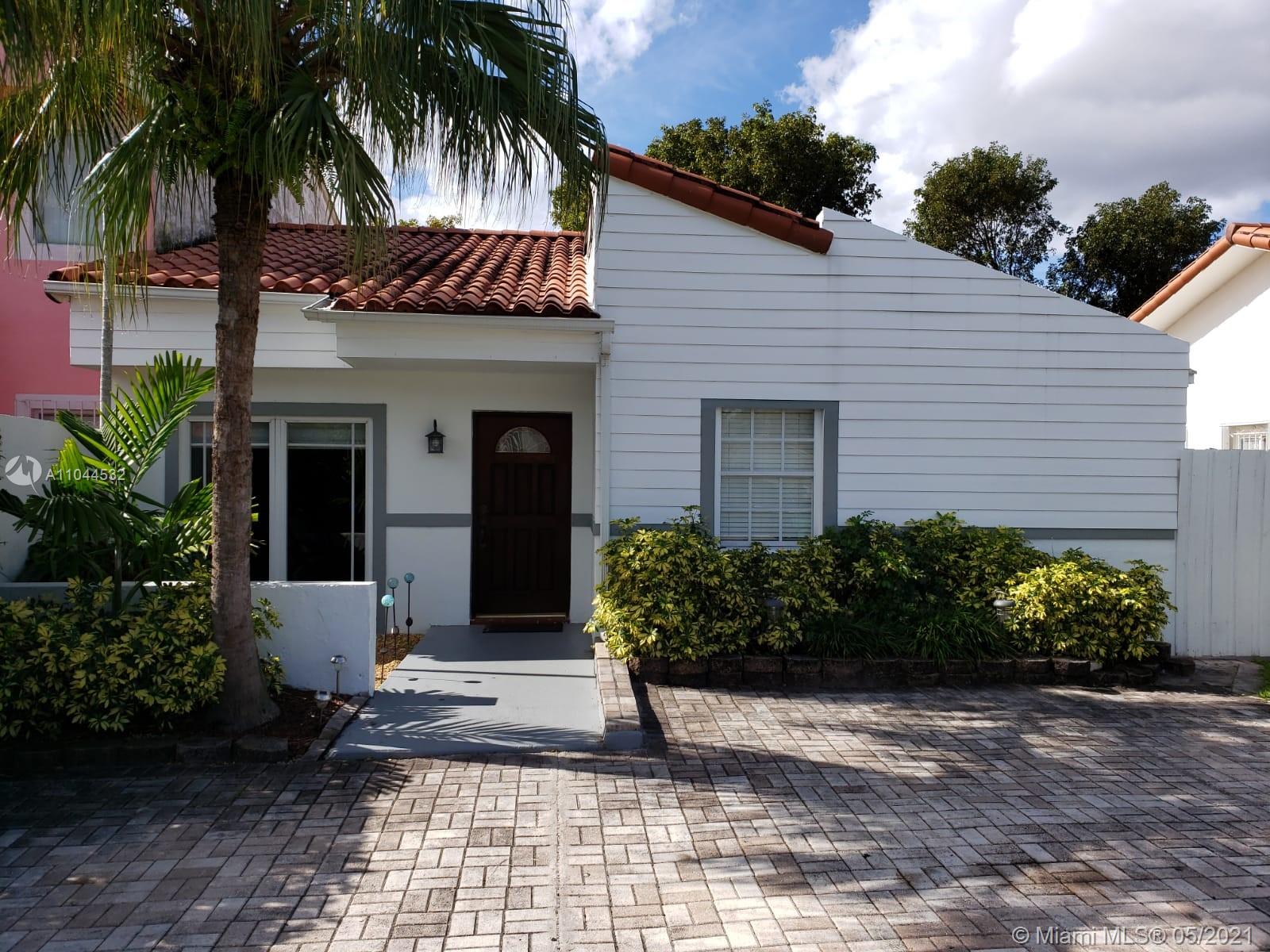 1404 Southwest 104th Court, Unit 89B Miami, FL 33174 - Photo 5 of 29 a front view of a house with a garden