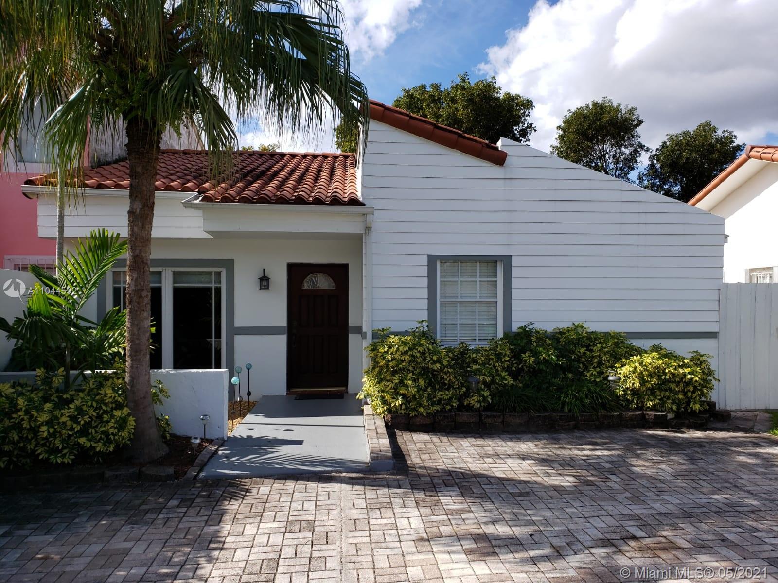 1404 Southwest 104th Court, Unit 89B Miami, FL 33174 - Photo 6 of 29 a view of a house with a yard and potted plants