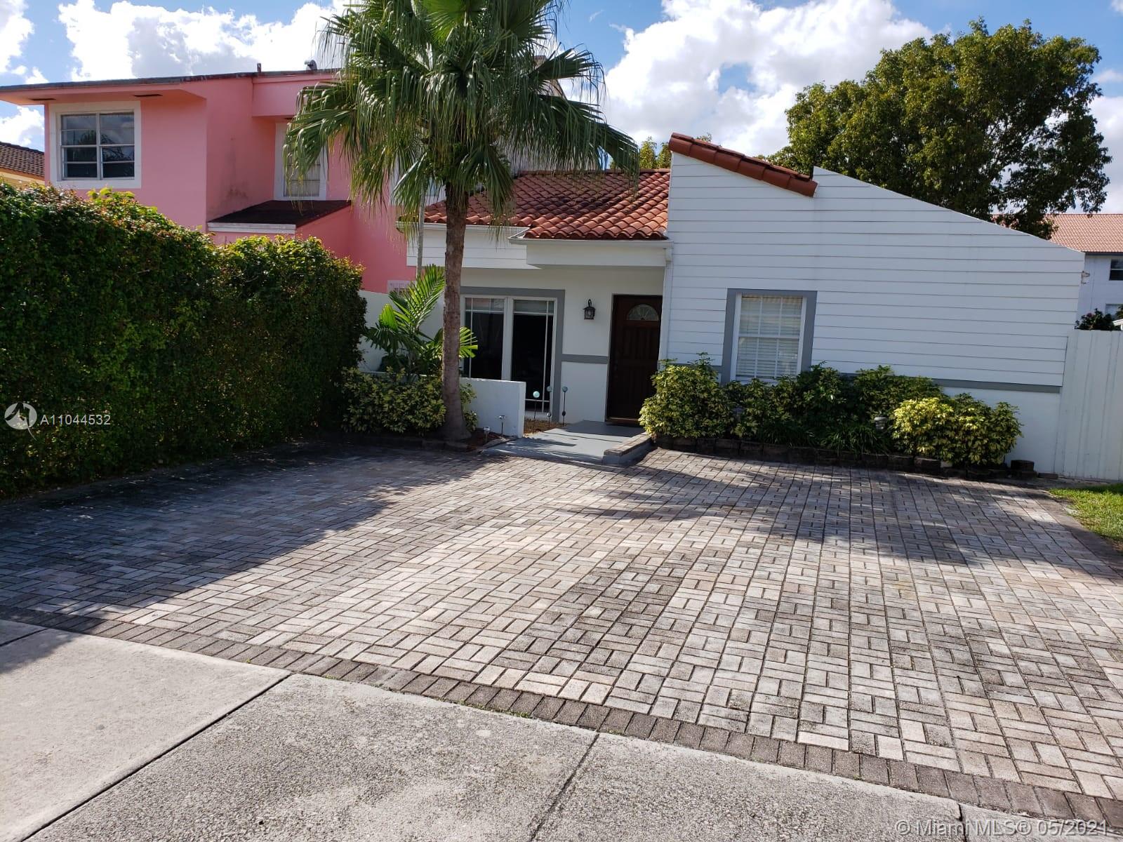 1404 Southwest 104th Court, Unit 89B Miami, FL 33174 - Photo 8 of 29 a front view of a house with a garden