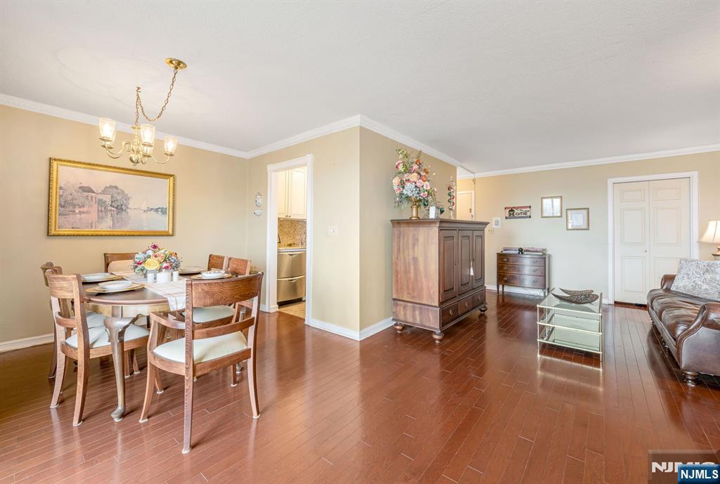 125 Prospect Avenue, Unit 16C Hackensack, NJ 07601 - Photo 12 of 35 a view of a dining room with furniture window and wooden floor