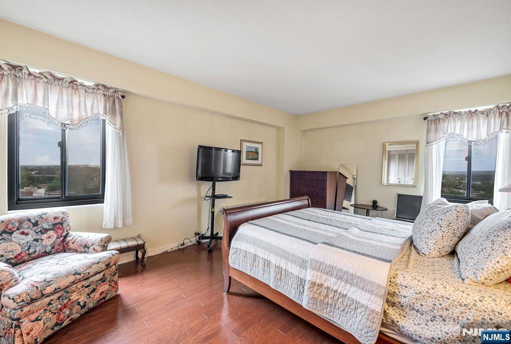 125 Prospect Avenue, Unit 16C Hackensack, NJ 07601 - Photo 23 of 35 a bedroom with a large bed and a couch