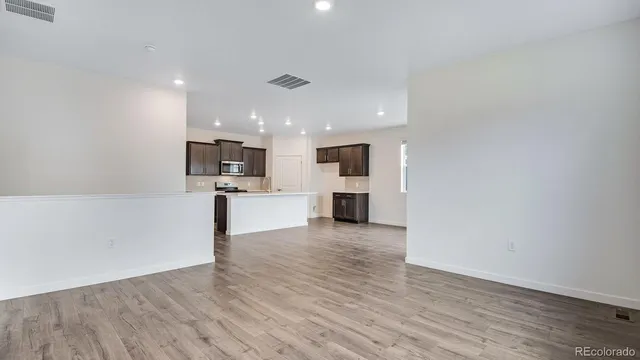 a view of kitchen with kitchen island microwave and stove
