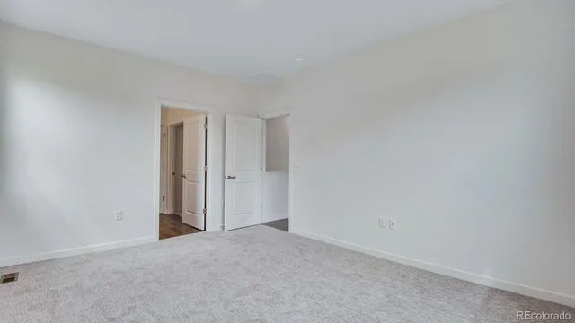 a view of an empty room and closet area