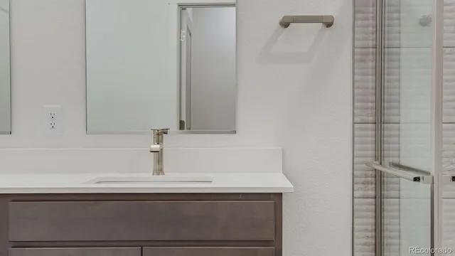a bathroom with a sink and vanity