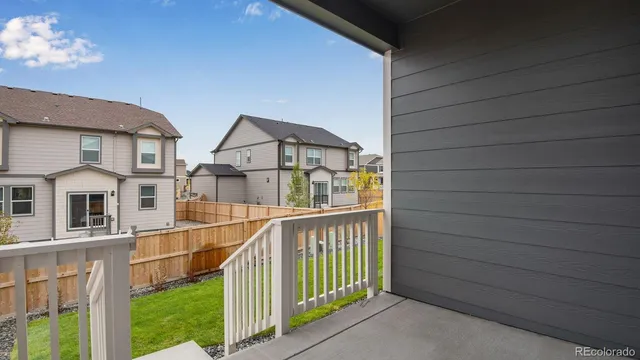 a view of a house with wooden fence