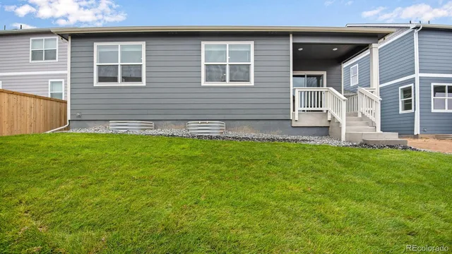 a view of front of a house with a yard and garage