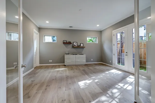 a view of empty room with wooden floor