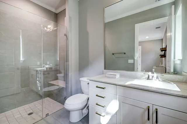 a bathroom with a sink toilet and shower
