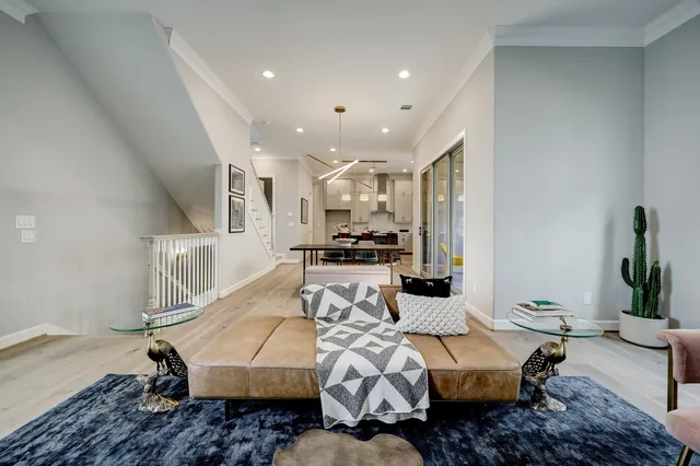 a living room with furniture wooden floor and a chandelier
